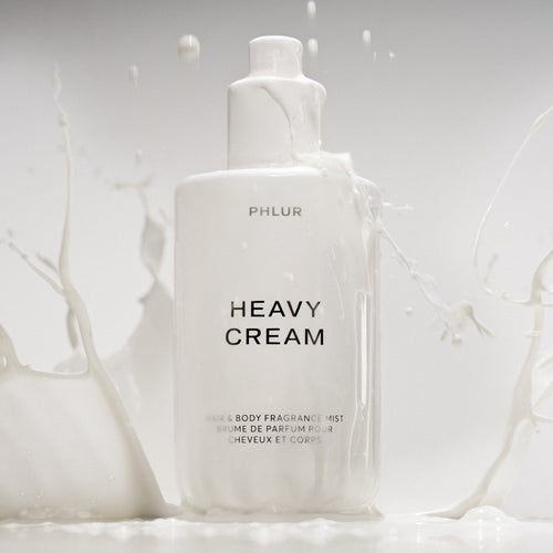 Phlur Heavy Cream body mist bottle in a milk splash